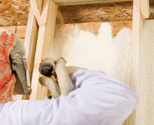 Spray foam installation being installed by a certified professional in Massachusetts